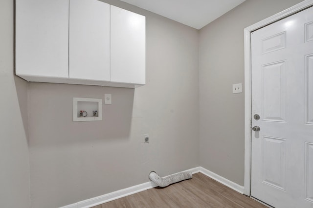 washroom featuring electric dryer hookup, cabinets, hookup for a washing machine, and light hardwood / wood-style flooring