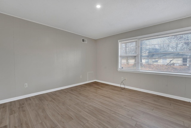 spare room with light hardwood / wood-style floors