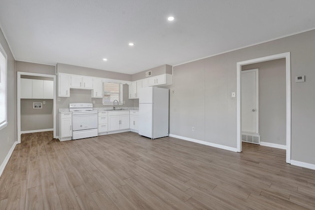 kitchen featuring light hardwood / wood-style flooring, white cabinets, white appliances, and sink