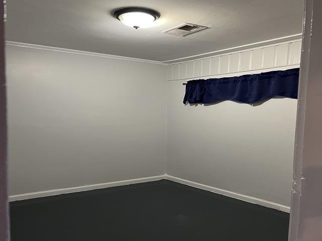 unfurnished room with crown molding