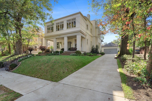 neoclassical / greek revival house featuring an outbuilding, covered porch, a front yard, and a detached garage