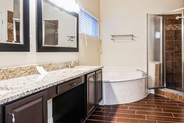 bathroom featuring shower with separate bathtub and vanity