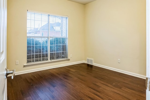 empty room with dark hardwood / wood-style flooring