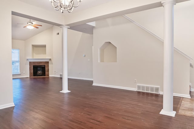 unfurnished living room with dark hardwood / wood-style floors, ceiling fan with notable chandelier, and a tile fireplace