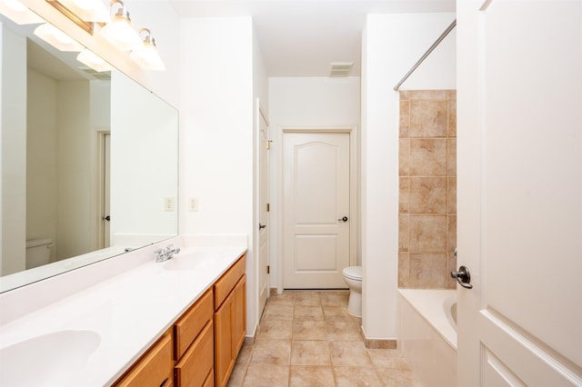 full bathroom featuring washtub / shower combination, toilet, and vanity