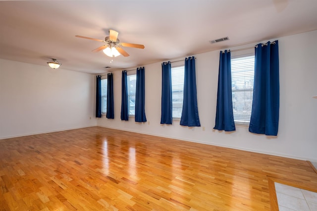 empty room featuring ceiling fan and light hardwood / wood-style floors