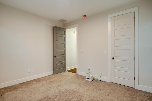 unfurnished bedroom with light colored carpet