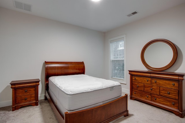 bedroom with light colored carpet