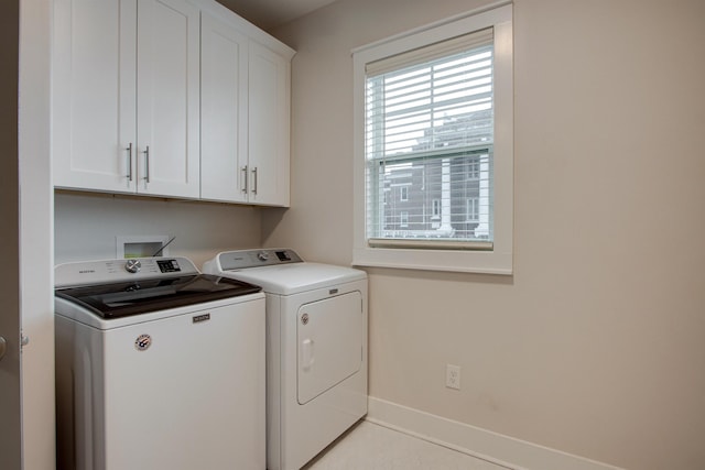 washroom with cabinets and independent washer and dryer