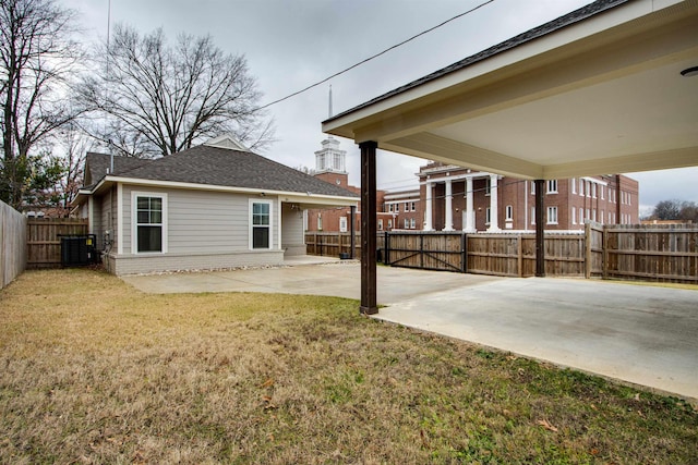 back of property featuring a yard, cooling unit, and a patio area