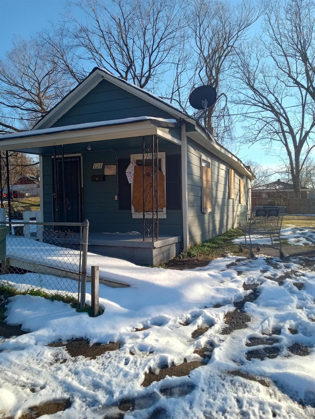 snow covered property featuring a porch