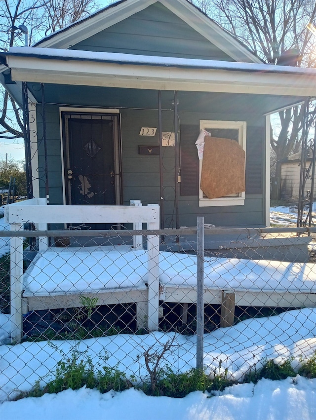 view of snow covered property entrance