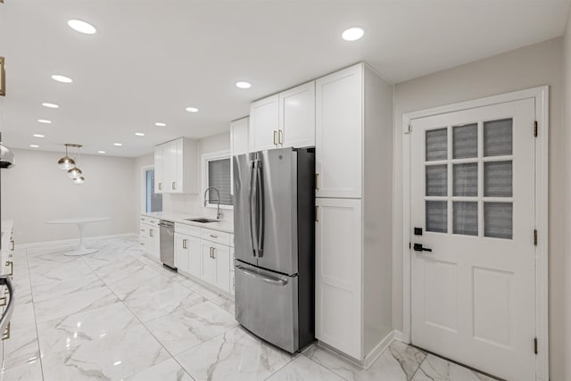 kitchen with sink, white cabinets, and appliances with stainless steel finishes