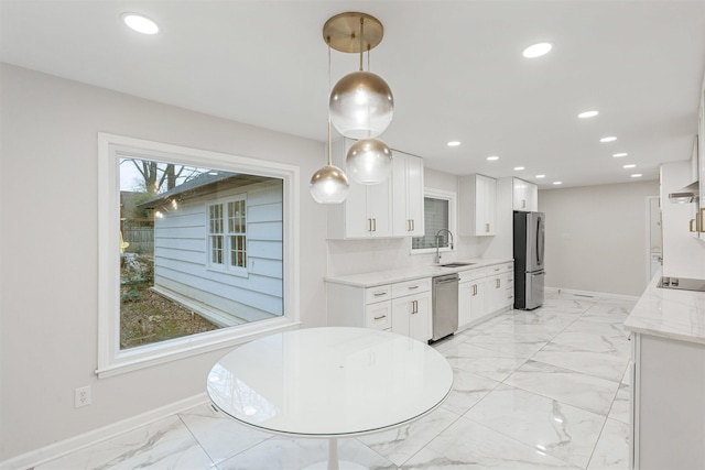 kitchen with white cabinets, pendant lighting, sink, and appliances with stainless steel finishes