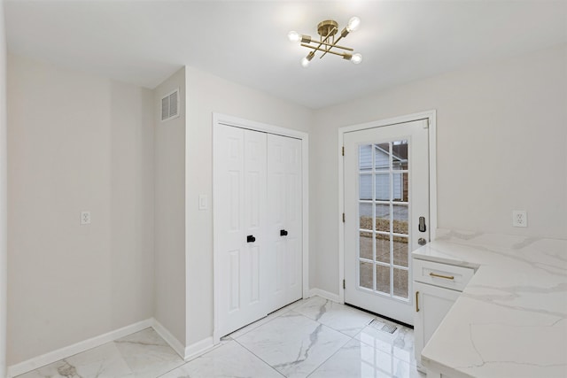 doorway to outside with a chandelier