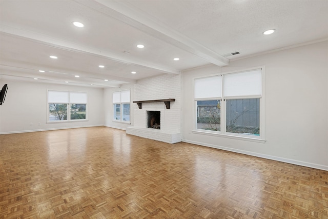 unfurnished living room featuring beamed ceiling, light parquet flooring, and a fireplace