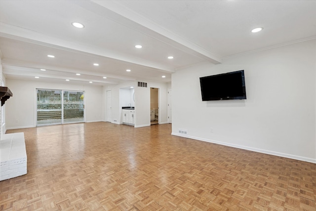 unfurnished living room featuring beam ceiling, crown molding, and light parquet floors