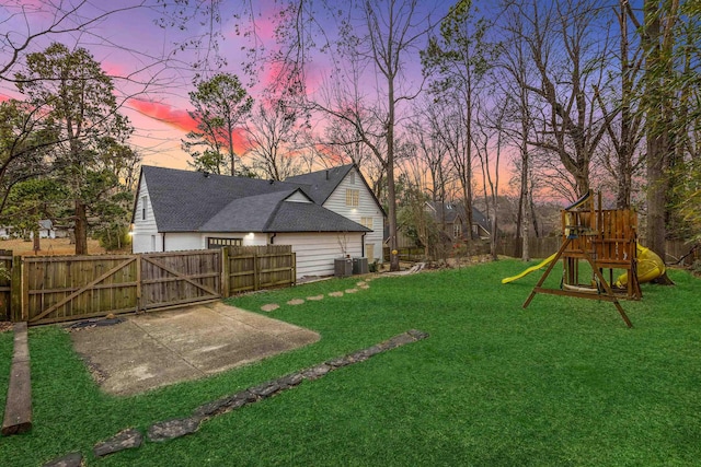 yard at dusk with a playground and cooling unit