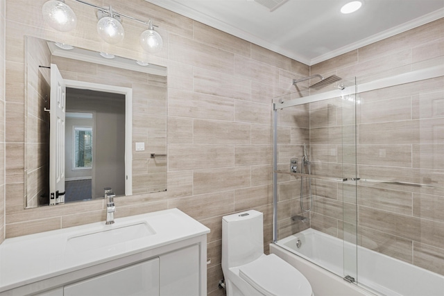 full bathroom with vanity, bath / shower combo with glass door, crown molding, toilet, and tile walls