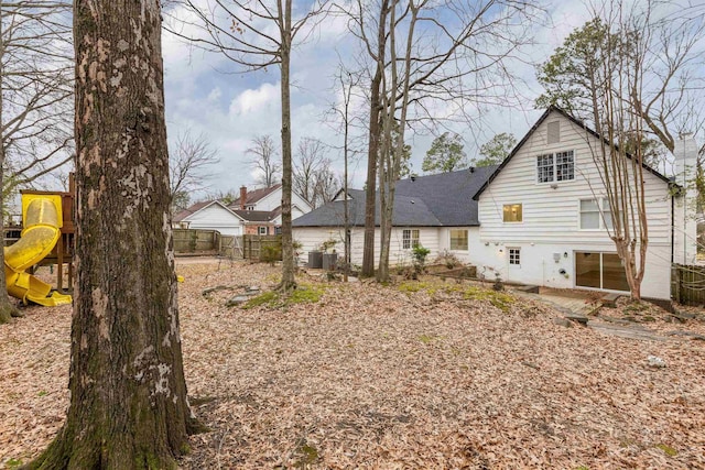 rear view of property with a playground