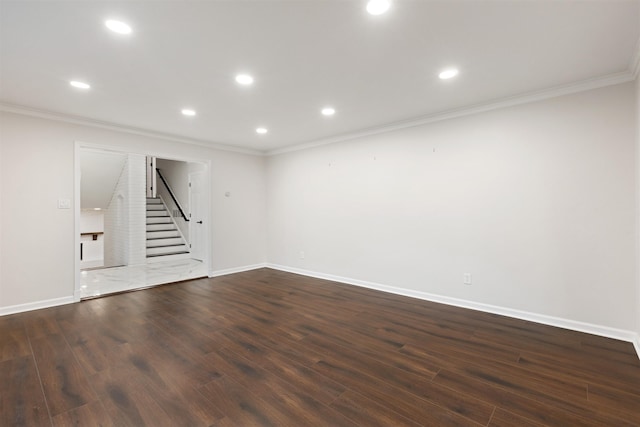 unfurnished living room featuring dark wood-type flooring and ornamental molding