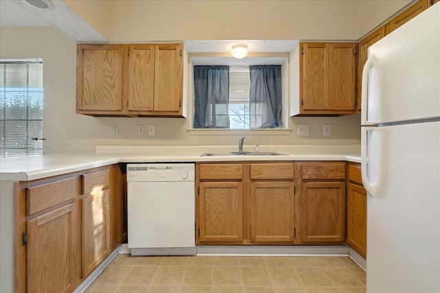 kitchen featuring white appliances and sink