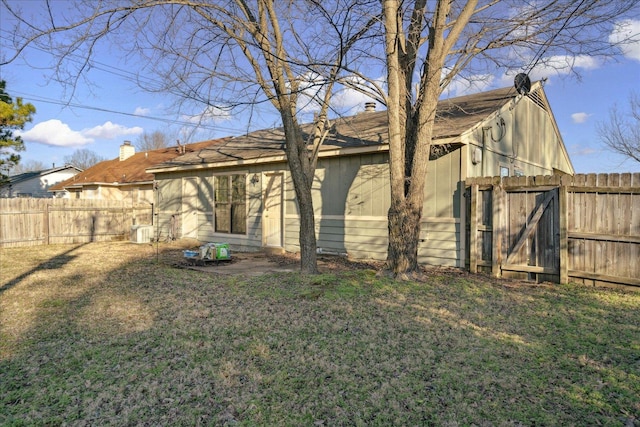 rear view of property featuring a lawn