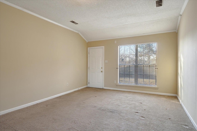 spare room with a textured ceiling, crown molding, and light carpet