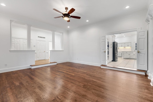 unfurnished living room featuring ceiling fan, light hardwood / wood-style floors, and ornamental molding