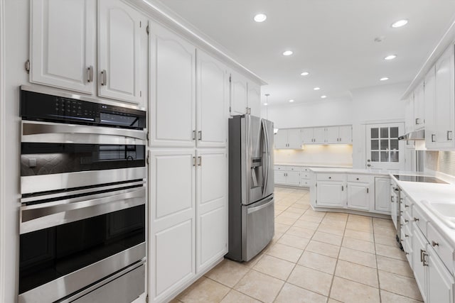 kitchen featuring sink, white cabinets, stainless steel appliances, and light tile patterned floors