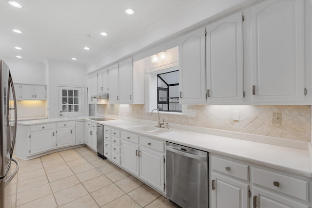 kitchen with white cabinetry, sink, stainless steel appliances, tasteful backsplash, and light tile patterned flooring