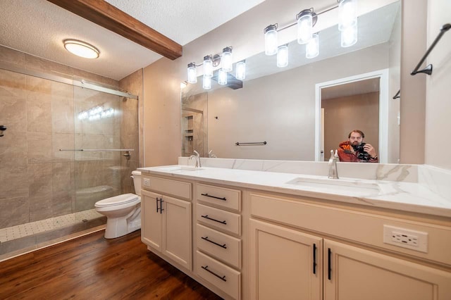 bathroom with vanity, hardwood / wood-style flooring, toilet, a textured ceiling, and beam ceiling