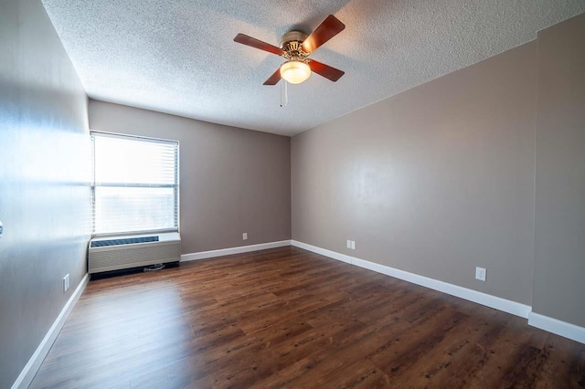 spare room featuring a textured ceiling, dark hardwood / wood-style floors, and ceiling fan