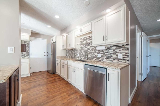 kitchen featuring light stone counters, sink, white cabinetry, and stainless steel appliances