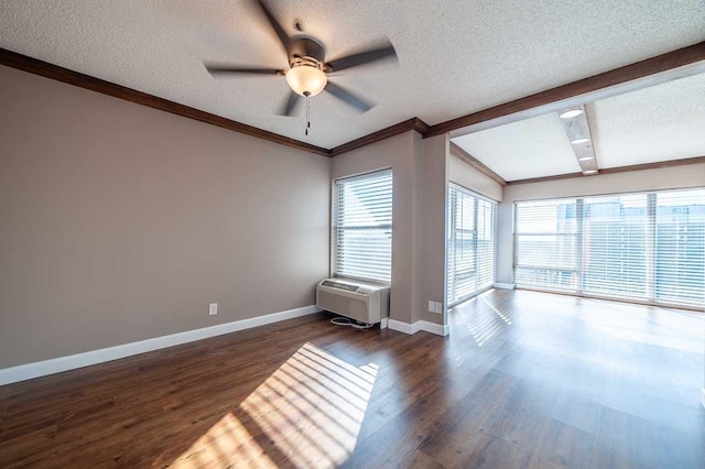 unfurnished living room with an AC wall unit, dark hardwood / wood-style floors, ceiling fan, ornamental molding, and a textured ceiling