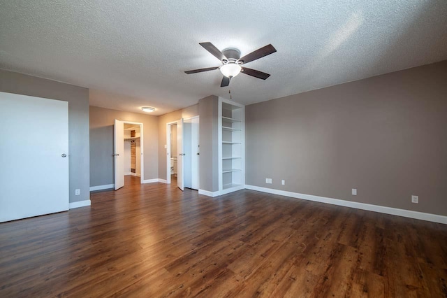 spare room with ceiling fan, dark hardwood / wood-style flooring, and a textured ceiling