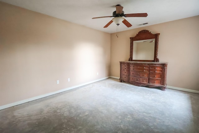 spare room with concrete floors and ceiling fan