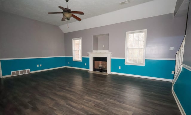 unfurnished living room with dark hardwood / wood-style flooring, vaulted ceiling, and ceiling fan