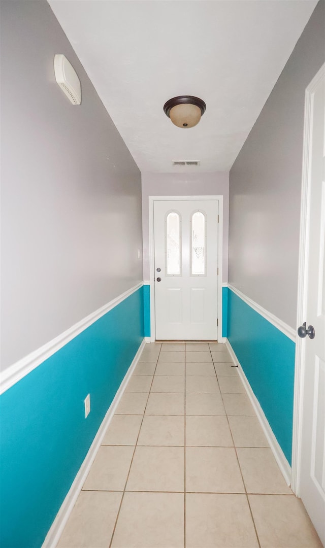 entryway with light tile patterned flooring