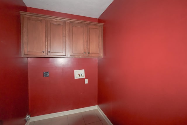 laundry room with washer hookup, cabinets, and light tile patterned flooring