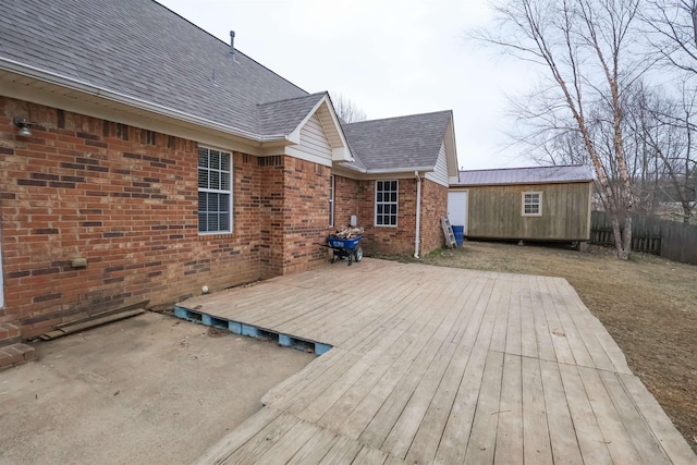 wooden terrace featuring an outbuilding