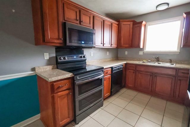 kitchen featuring sink, light tile patterned flooring, and appliances with stainless steel finishes