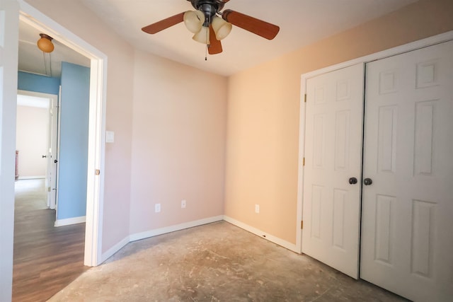 unfurnished bedroom with concrete flooring, a closet, and ceiling fan