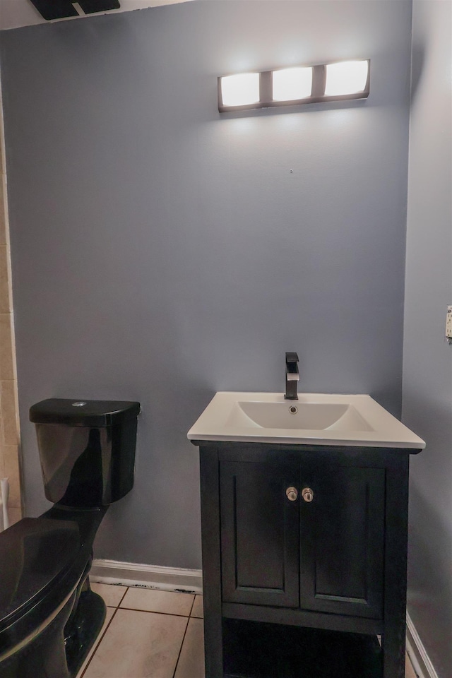 bathroom with vanity, tile patterned floors, and toilet