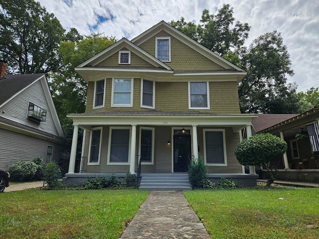 view of front of house with a porch and a front yard