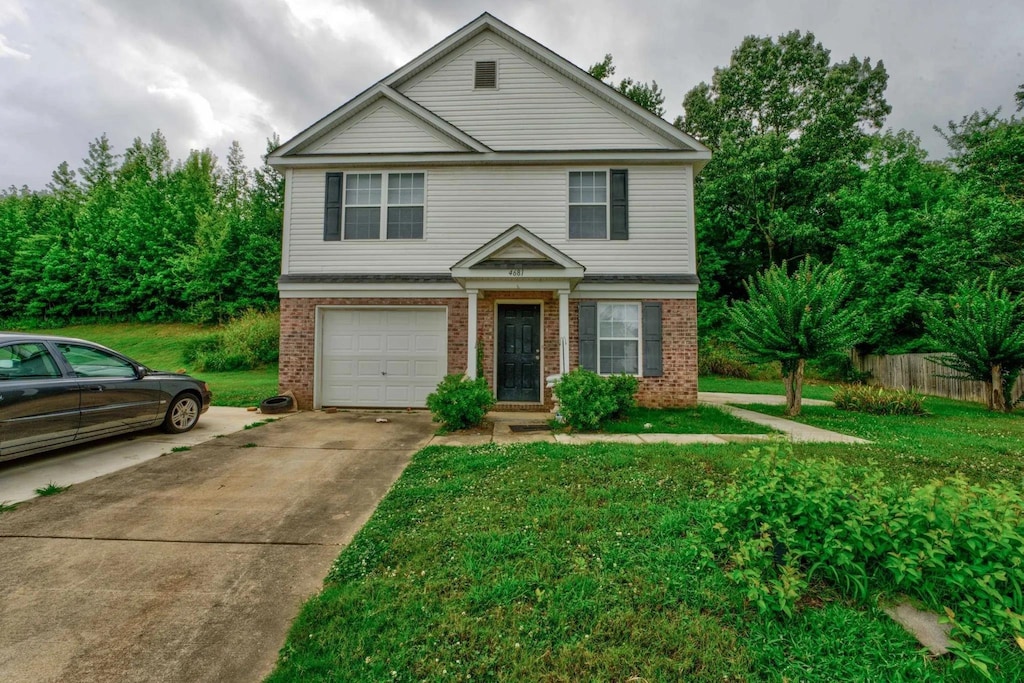 view of front property with a front yard and a garage