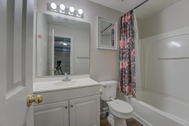 full bathroom featuring shower / bathtub combination with curtain, vanity, a textured ceiling, and toilet