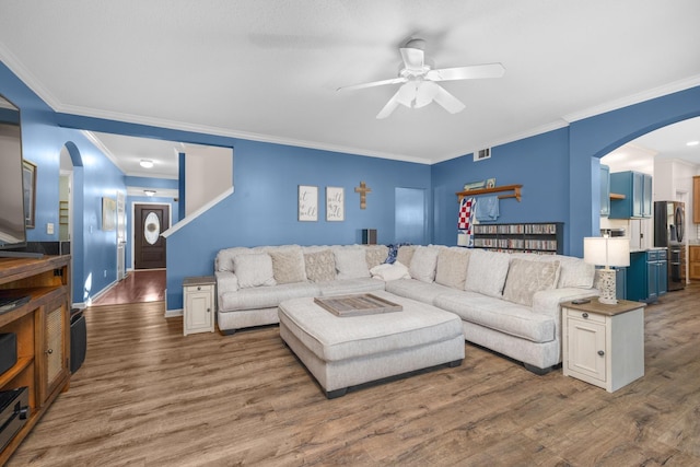 living room featuring crown molding, hardwood / wood-style flooring, and ceiling fan