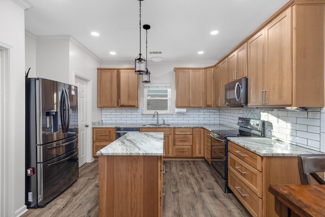 kitchen with sink, hanging light fixtures, a kitchen island, stainless steel appliances, and light stone countertops