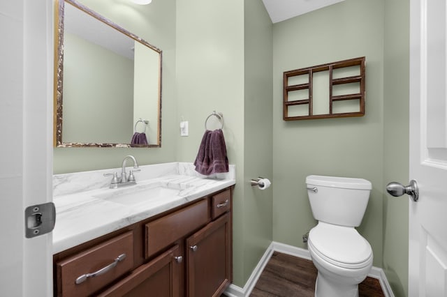 bathroom featuring vanity, hardwood / wood-style floors, and toilet